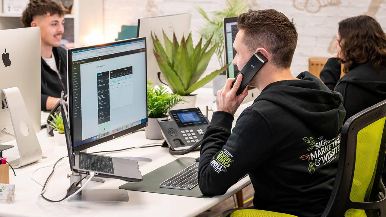 Image of professional web designer Exeter Devon working on client websites in modern office.