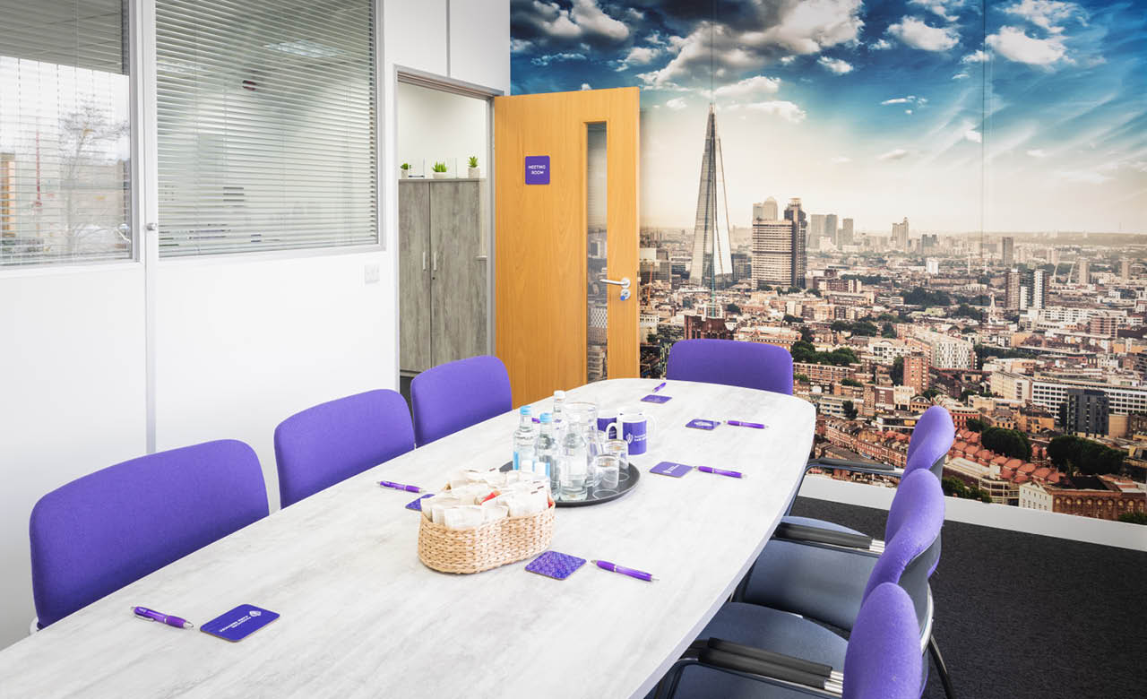 Boardroom with printed wall graphics, pens, and coasters. All designed by the Nettl of Exeter creative team.