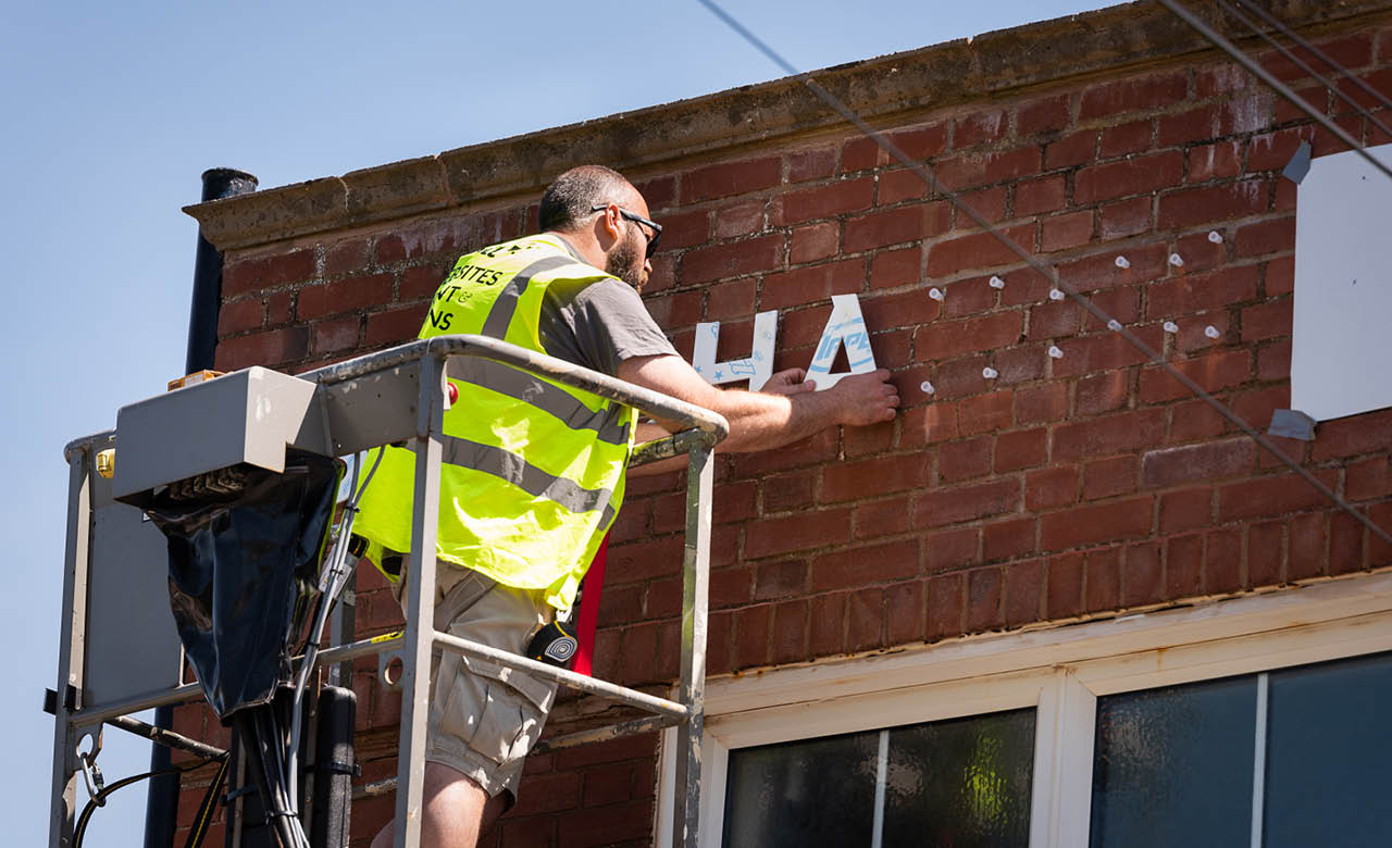 Bespoke letters being fit on the exterior of the building by the Nettl of Exeter team.