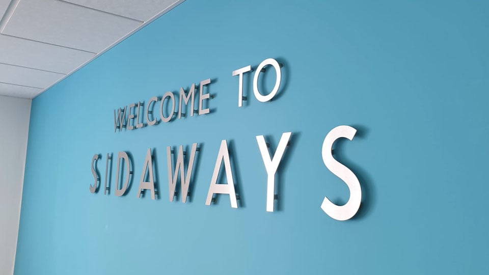 Individual cut lettering on standoffs created and installed by Nettl of Exeter.