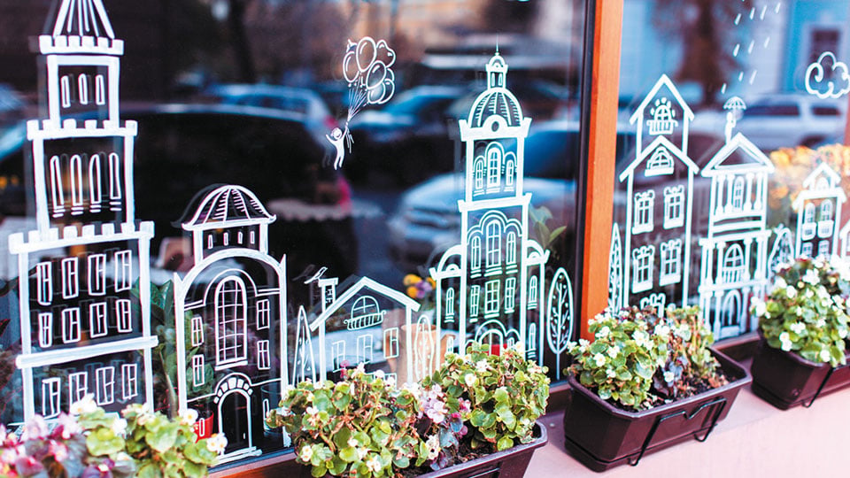 Town scene created out of cut vinyl and applied to the base of a window pane to create a stunning scene. Installed by the Nettl team on a shop.