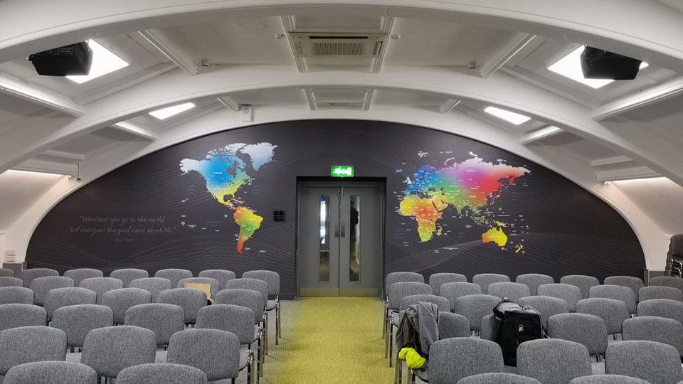 Wall wrap showing the world map highlighted with different colours. This graphic was installed by our Exeter based installation team.