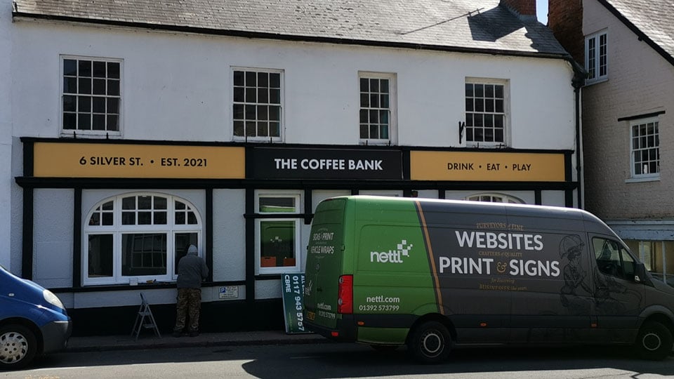 The Nettl of Exeter van parked outside the Coffee Bank in Exeter where the team have just installed new shop signage.