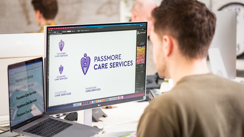 Tom working on a branding and logo design project for Passmore Care Services, an Exeter-based care business.